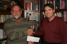 Tim hetzner receives check from Craig Barbret of Project 12 Baskets